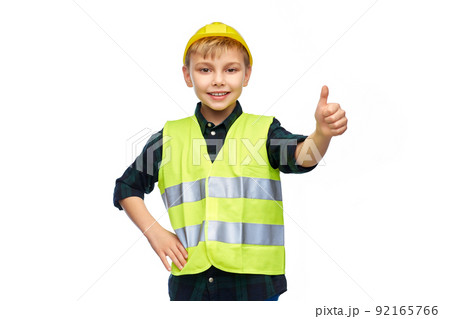 happy boy in construction helmet showing thumbs up happy boy in construction helmet showing thumbs up 92165766