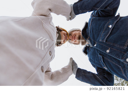 happy smiling couple holding hands in winter park 92165821