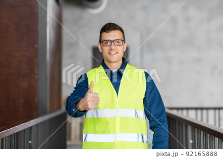 male architect in safety west showing thumbs up 92165888
