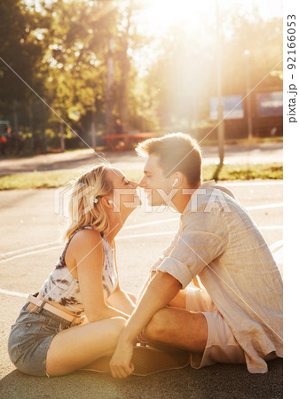 happy couple with earphones listening to music 92166053