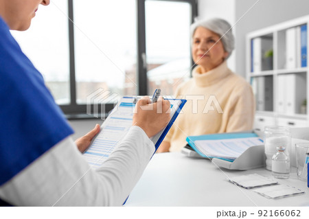 doctor with clipboard and senior woman at hospital 92166062
