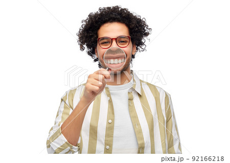 man showing his teeth through magnifying glass man showing his teeth through magnifying glass 92166218