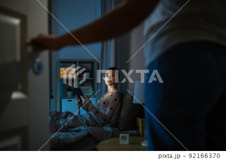 teenage girl with tablet pc in bed at night 92166370