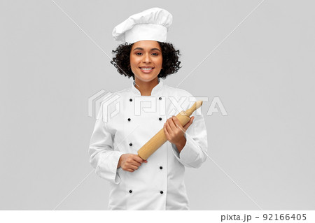 smiling female chef or baker with rolling pin smiling female chef or baker with rolling pin 92166405