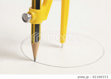 Yellow compass with pencil isolated on white background 92166553
