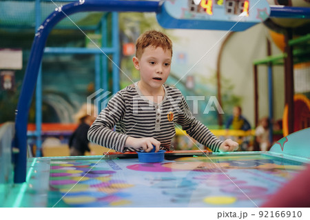 little child plays in air hokey in Entertainment Center little child plays in air hokey in Entertainment Center 92166910