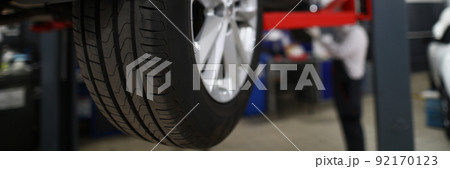 Brand new automobile tire, changed part of vehicle in service centre Brand new automobile tire, changed part of vehicle in service centre 92170123