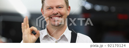 Car repair service worker show ok gesture with hand and smiling Car repair service worker show ok gesture with hand and smiling 92170124