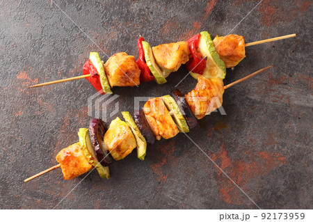 Tasty chicken shashlik on dark textured background Tasty chicken shashlik on dark textured background 92173959