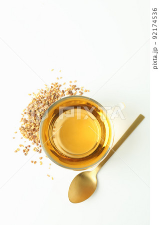 Concept of hot drink with buckwheat tea on white background Concept of hot drink with buckwheat tea on white background 92174536