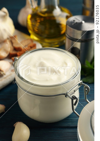 Concept of cooking garlic sauce on wooden background Concept of cooking garlic sauce on wooden background 92176035