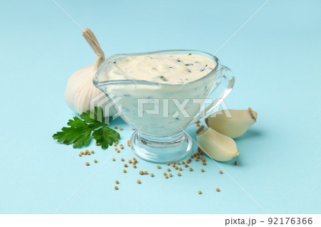 Garlic sauce and ingredients on blue background 92176366