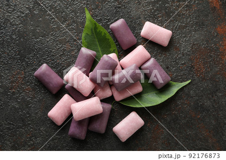 Chewing or bubble gum on dark textured background 92176873