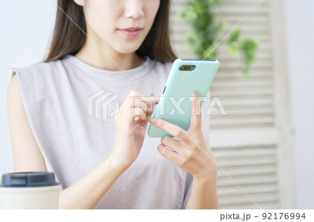 リビングでスマホを使う女性　顔無し 92176994