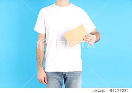 Man in blank white t-shirt on blue background 92177054