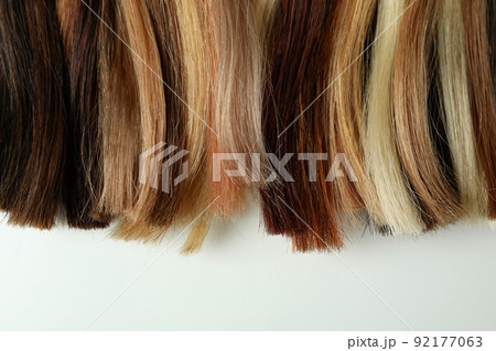 Different color female hair on white background Different color female hair on white background 92177063