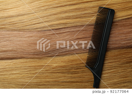 Female hair with hairbrush on whole background Female hair with hairbrush on whole background 92177064