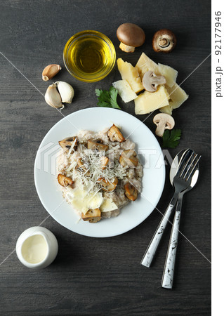 Concept of tasty food with risotto with mushrooms on dark wooden table Concept of tasty food with risotto with mushrooms on dark wooden table 92177946