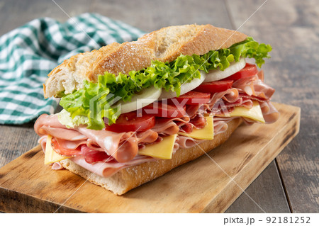 Submarine sandwich with ham, cheese, lettuce, tomatoes,onion, mortadella and sausage Submarine sandwich with ham, cheese, lettuce, tomatoes,onion, mortadella and sausage 92181252
