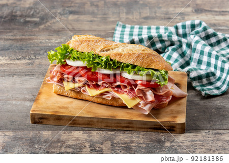 Submarine sandwich with ham, cheese, lettuce, tomatoes,onion, mortadella and sausage 92181386