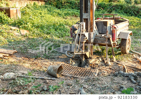 Rotary drilling rig at a construction site.Sludge flow from the joule during the water well drilling 92183330