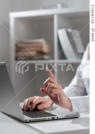 Businesswoman Typing Recent Updates On Lap Top Keyboard On Desk And Pointing Important Ideas With One Finger. Woman In Office Writing Late Messages On Computer. Businesswoman Typing Recent Updates On Lap Top Keyboard On Desk And Pointing Important Ideas With One Finger. Woman In Office Writing Late Messages On Computer. 92184613