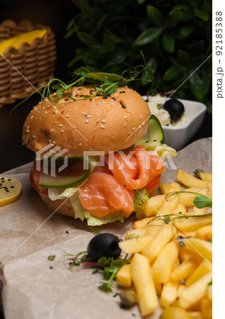 burger with salmon, vegetables and french fries burger with salmon, vegetables and french fries 92185388