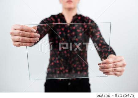 Businesswoman Holding Rectangular Glass While Displaying Important Data. Woman Wearing Floral T-Shirt Showing Transparent Banner While Advertising The Company. 92185478