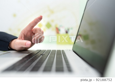 Businesswoman With Lap Top On Desk Pointing Important Messages With One Finger. Executive In Office Having Computer And Presenting Crutial Informations. Businesswoman With Lap Top On Desk Pointing Important Messages With One Finger. Executive In Office Having Computer And Presenting Crutial Informations. 92188752