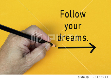 FOLLOW YOUR DREAMS text written on a yellow background. Business concept. 92188943
