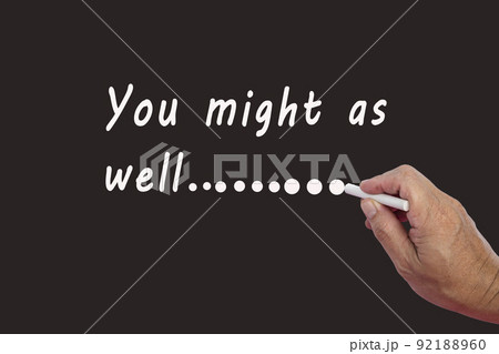 Male hand writes in white chalk pencil the word YOU MIGHT AS WELL. Male hand writes in white chalk pencil the word YOU MIGHT AS WELL. 92188960