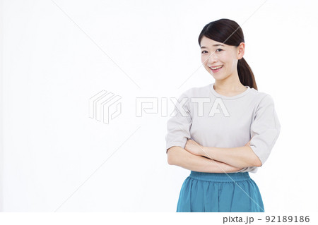腕組みをして笑顔で考えている30代の女性 92189186