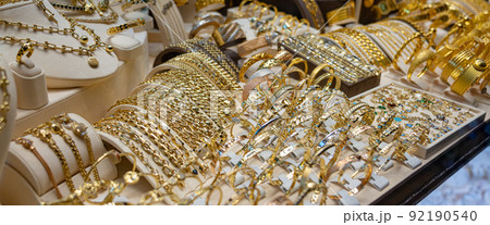 Many golden bracelets on stand in jewelry close up Many golden bracelets on stand in jewelry close up 92190540