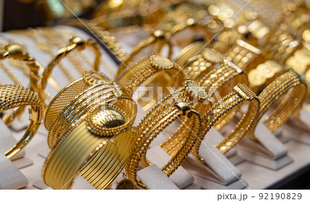 Many golden bracelets on stand in jewelry close up Many golden bracelets on stand in jewelry close up 92190829