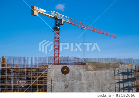 Cranes building structure against blue sky 92192666