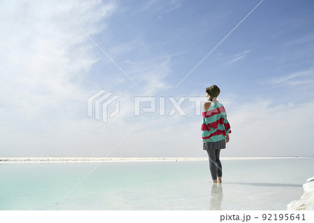 asian female tourist standing in water of a salt lake asian female tourist standing in water of a salt lake 92195641