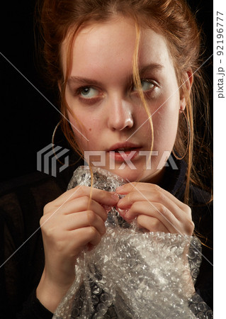 woman bursts bubbles 92196777