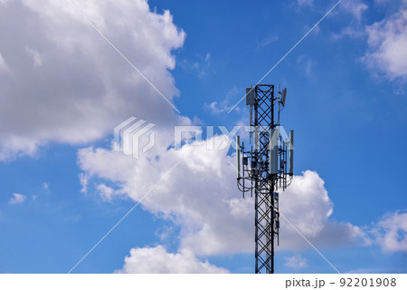 Telecommunication towers with clouds on blue sky background Telecommunication towers with clouds on blue sky background 92201908