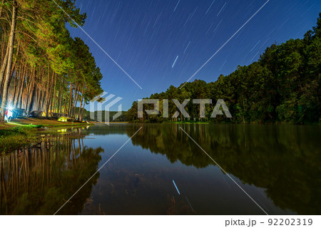 Landscape of Night camping with stars tail in Pang-Ung pine forest trees and nature, Mae hong son, Thailand, Asia. 92202319