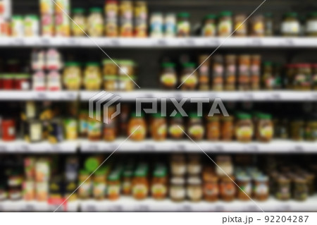 blurry supermarket selves with pickled vegetables and mushrooms in jars 92204287