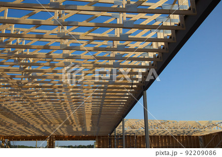 building under construction wood roof structure beams planks house development frame 92209086