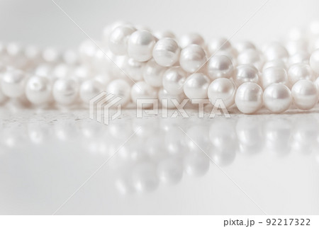 Nature white string of pearls on marble background in soft focus, with highlights Nature white string of pearls on marble background in soft focus, with highlights 92217322