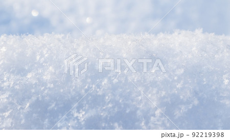 Background of fresh snow. Natural winter background. Snow texture in blue tone 92219398