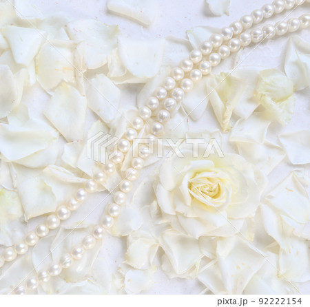 Beautiful white rose with petals and pearl necklace on white background. Ideal for greeting cards for wedding, birthday, Valentine's Day, Mother's Day Beautiful white rose with petals and pearl necklace on white background. Ideal for greeting cards for wedding, birthday, Valentine's Day, Mother's Day 92222154
