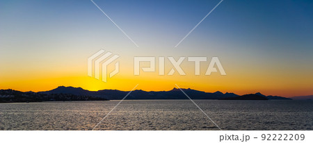 Beautiful bright colorful sunset on the Mediterranean Sea with islands, mountains and boats Beautiful bright colorful sunset on the Mediterranean Sea with islands, mountains and boats 92222209