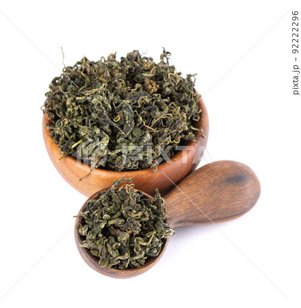 Dry gynostemma pentaphyllum leaf in wooden bowl and spoon, isolated on white blackground. Jiaogulan or Miracle grass. Chinese herbal tea. 92222296