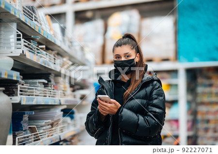 Woman with face mask buying during virus pandemic. Woman with face mask buying during virus pandemic. 92227071