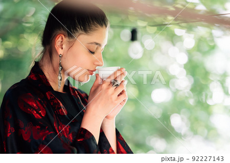 Shot of young woman drinking from tea bowl 92227143