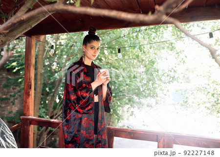 Shot of young woman drinking from tea bowl Shot of young woman drinking from tea bowl 92227148