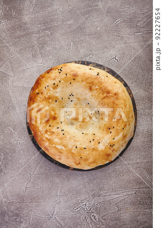 Delicious fresh tandir flatbread with black and white sesame seeds. National traditional Asian food Delicious fresh tandir flatbread with black and white sesame seeds. National traditional Asian food 92227654